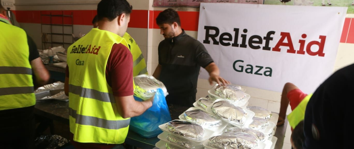 ReliefAid’s team cooks meals in a makeshift kitchen and package for delivery.